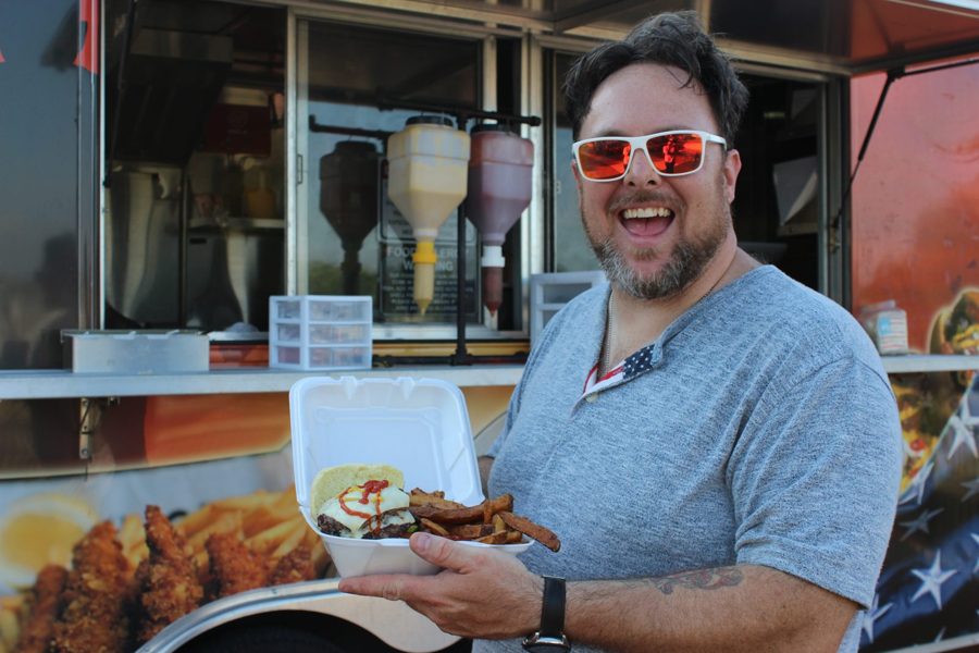 Happy customer with a burger from Veterans Lunch Box